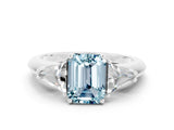 White gold Three-Stone Emerald Cut Cut Diamond Ring with Trillion Side Stones and Four-Prong Setting