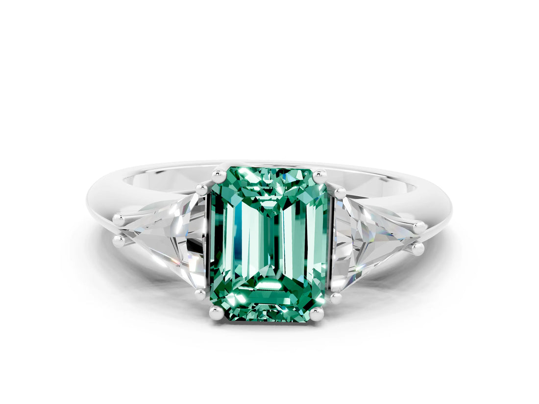 White gold Three-Stone Emerald Cut Cut Diamond Ring with Trillion Side Stones and Four-Prong Setting