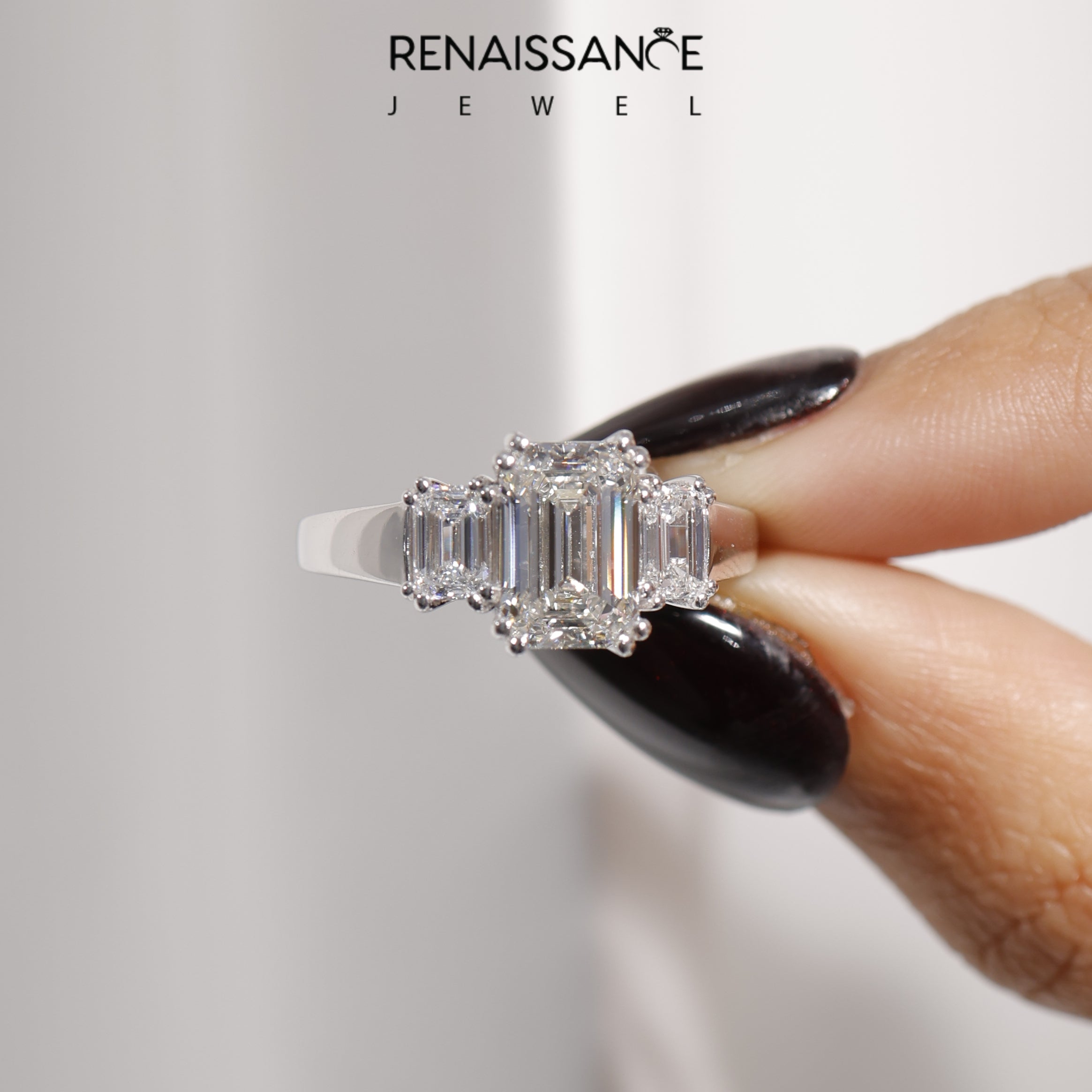 White gold Three-Stone Emerald Cut Diamond Ring with Channel Set Band and Four-Prong Setting_48