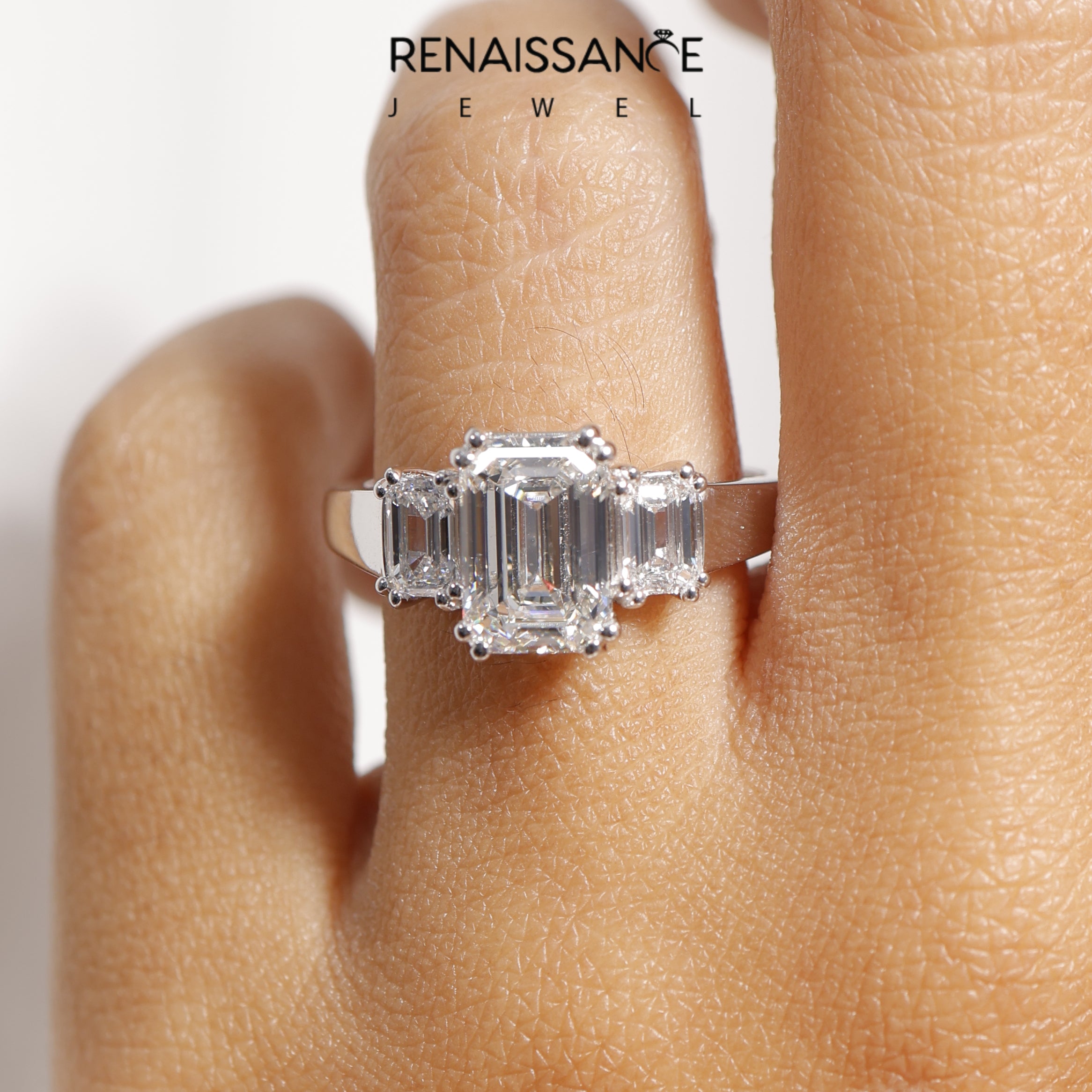 White gold Three-Stone Emerald Cut Diamond Ring with Channel Set Band and Four-Prong Setting_50