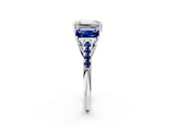White gold Three-Stone Emerald Cut Diamond Ring with Round with Blue Sapphire side stone Pavé Band and Prong Setting_26