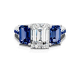 White gold Three-Stone Emerald Cut Diamond Ring with Round with Blue Sapphire side stone Pavé Band and Prong Setting