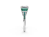 White gold Three-Stone Emerald Cut Diamond Ring with Round with Green Sapphire side stone Pavé Band and Prong Setting_26