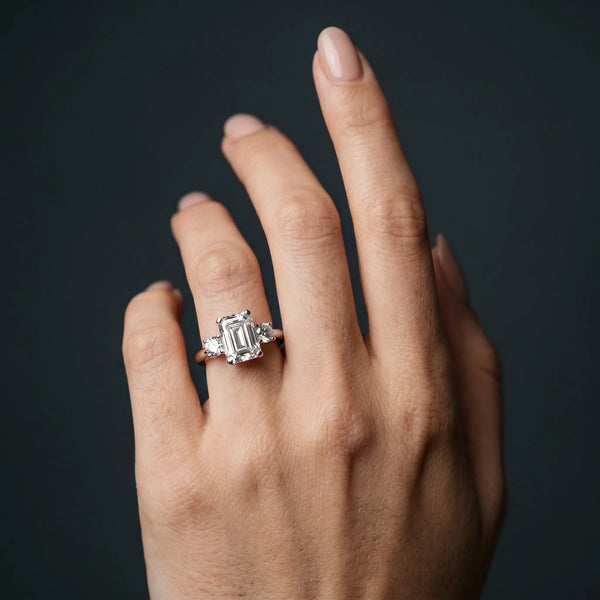 White gold Three-Stone Emerald Cut Diamond Solitaire with Prong Setting and Classic Band
