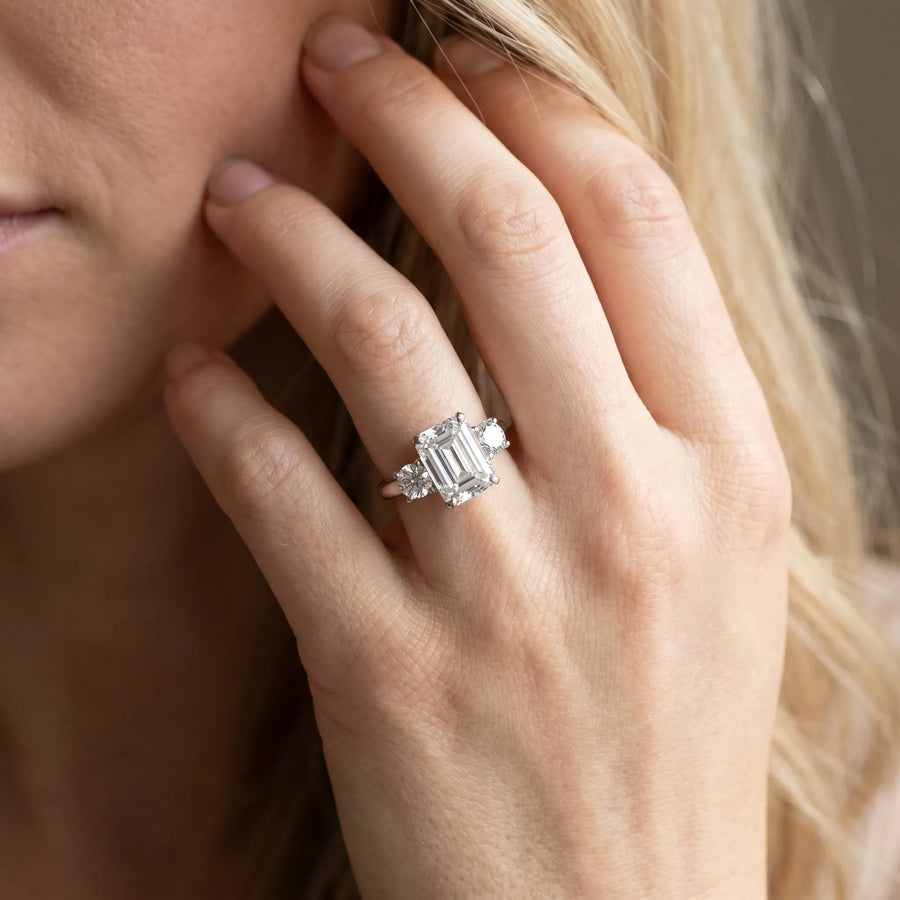 White gold Three-Stone Emerald Cut Diamond Solitaire with Prong Setting and Classic Band