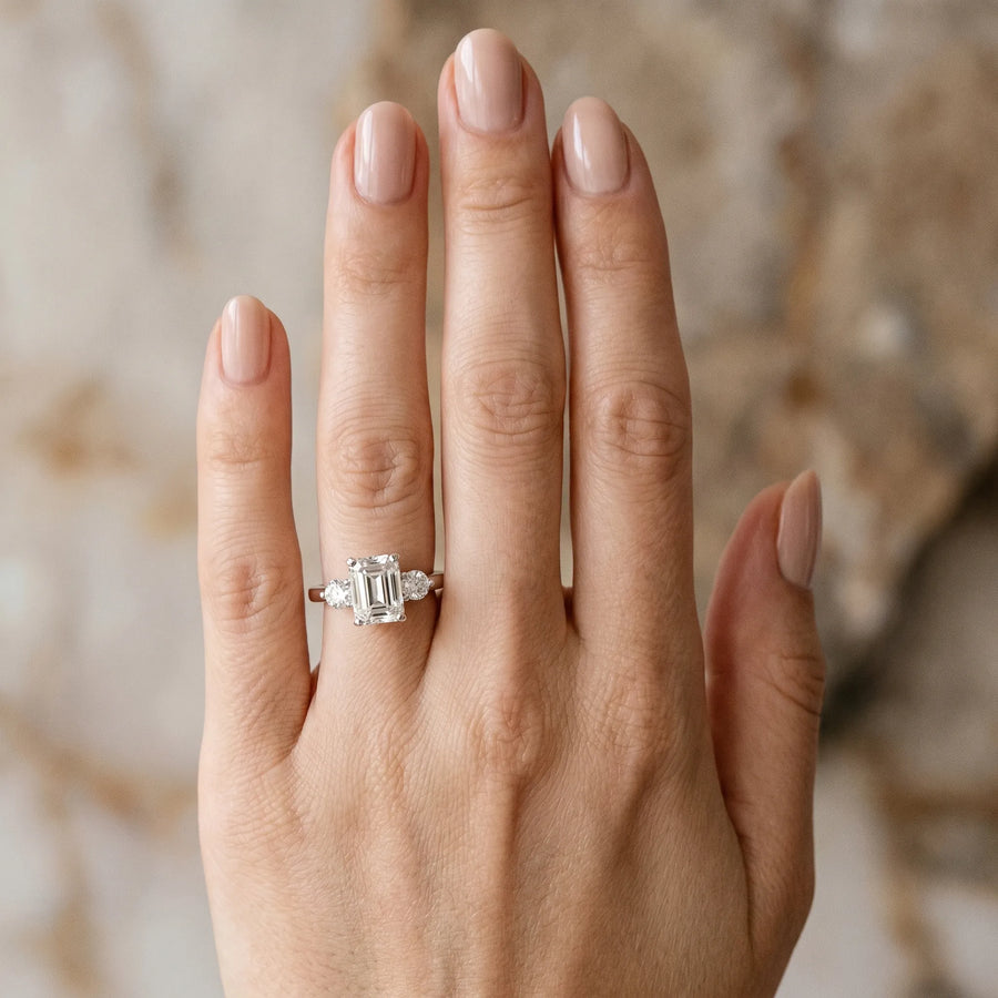 White gold Three-Stone Emerald Solitaire Ring with Tapered Band and Four-Prong Setting