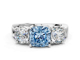 White gold Three-Stone Fancy Blue Cushion Cut Diamond Ring with Round Side Stones, Classic Band, and Four-Prong Setting