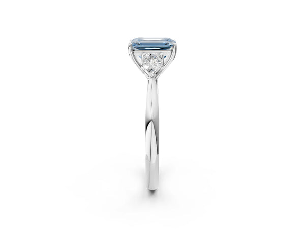 White gold Three-Stone Fancy Blue Emerald Cut Brilliant Diamond Solitaire Ring with Tapered Band and Four-Prong Setting