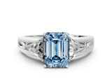 White gold Three-Stone Fancy Blue Emerald Cut Cut Diamond Ring with Trillion Side Stones on a Split Shank Band