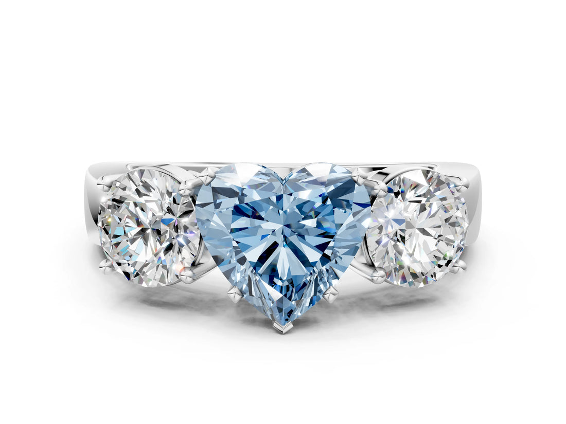 White gold Three-Stone Fancy Blue Heart Cut Diamond Ring with Round Side Stones, Classic Band, and Four-Prong Setting