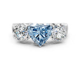White gold Three-Stone Fancy Blue Heart Cut Diamond Ring with Round Side Stones, Classic Band, and Four-Prong Setting