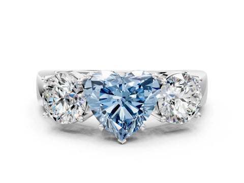 White gold Three-Stone Fancy Blue Heart Cut Diamond Ring with Round Side Stones, Classic Band, and Four-Prong Setting