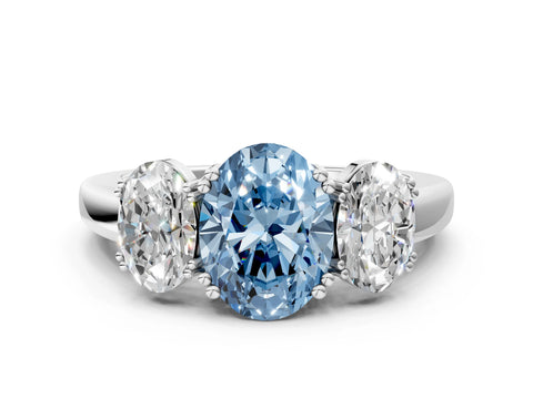 White gold Three-Stone Fancy Blue Oval Cut Cut Diamond Ring with Channel Set Band and Four-Prong Setting