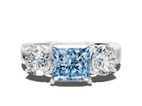 White gold Three-Stone Fancy Blue Princess Cut Diamond Ring with Round Side Stones, Classic Band, and Four-Prong Setting