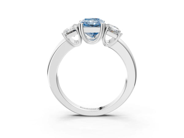 Platinum Three-Stone Fancy Blue Radiant Cut Cut Diamond Ring with Channel Set Band and Four-Prong Setting