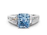 White gold Three-Stone Fancy Blue Radiant Cut Cut Diamond Ring with Trillion Side Stones on a Split Shank Band
