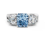 White gold Three-Stone Fancy Blue Radiant Cut Diamond Ring with Round Side Stones, Classic Band, and Four-Prong Setting