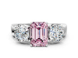 White gold Three-Stone Fancy Pink Emerald Cut Diamond Ring with Round Side Stones, Classic Band, and Four-Prong Setting