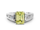 White gold Three-Stone Fancy Yellow Emerald Cut Cut Diamond Ring with Trillion Side Stones on a Split Shank Band