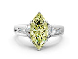 White gold Three-Stone Fancy Yellow Marquise Cut Cut Diamond Ring with Trillion Side Stones on a Split Shank Band