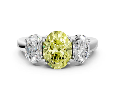White gold Three-Stone Fancy Yellow Oval Cut Cut Diamond Ring with Channel Set Band and Four-Prong Setting
