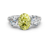 White gold Three-Stone Fancy Yellow Oval Cut Cut Diamond Ring with Channel-Set Band and Prong Setting