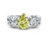 White gold Three-Stone Fancy Yellow Pear Cut Diamond Ring with Round Side Stones, Classic Band, and Four-Prong Setting
