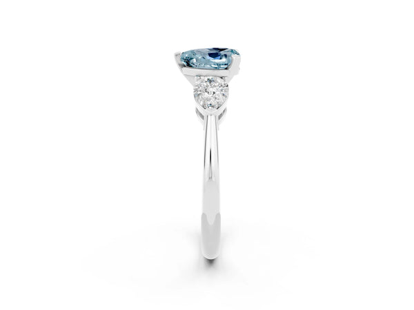 White gold Three-Stone Heart Cut Aquamarine Ring with Pear Side Stones and Four-Prong Setting