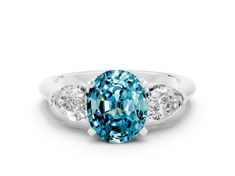 White gold Three-Stone Oval Cut Blue Topaz Ring with Pear Side Stones and Four-Prong Setting
