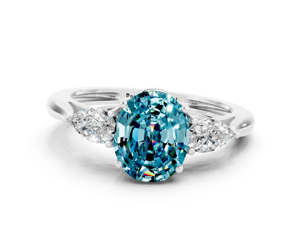 Platinum Three-Stone Oval Cut Blue Topaz Ring with Pear  Side Stones in Four-Prong Setting