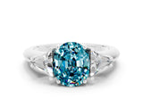 White gold Three-Stone Oval Cut Cut Diamond Ring with Trillion Side Stones and Four-Prong Setting
