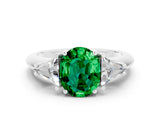 White gold Three-Stone Oval Cut Cut Diamond Ring with Trillion Side Stones and Four-Prong Setting