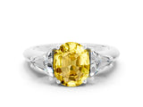 White gold Three-Stone Oval Cut Cut Diamond Ring with Trillion Side Stones and Four-Prong Setting