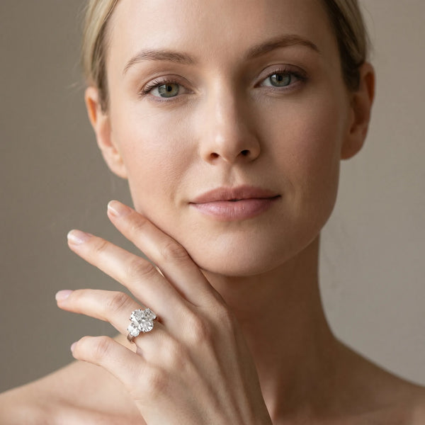 White gold Three-Stone Oval Cut Diamond Ring with Channel Set Band and Four-Prong Setting