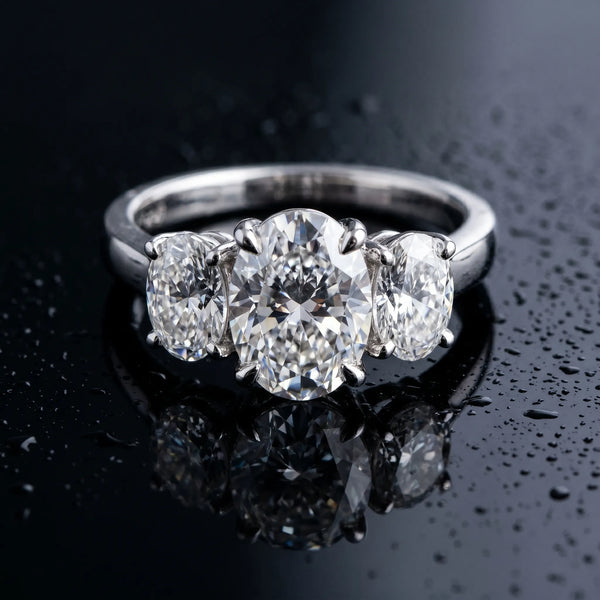 White gold Three-Stone Oval Cut Diamond Ring with Channel Set Band and Four-Prong Setting