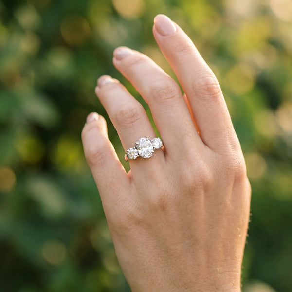 White gold Three-Stone Oval Cut Diamond Ring with Round Accent Stones, Prong Setting, and Classic Band