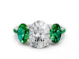White gold Three-Stone Oval Cut Diamond Ring with Round with Emerald side stone Pavé Band and Prong Setting