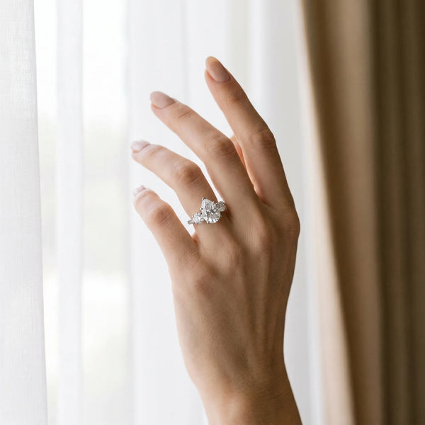 White gold Three-Stone Pear Cut Diamond Engagement Ring with Prong Setting on a White Gold Band