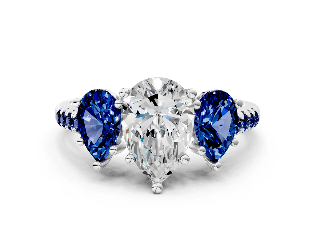 White gold Three-Stone Pear Cut Diamond Ring with Round with Blue Sapphire side stone Pavé Band and Prong Setting