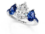 White gold Three-Stone Pear Cut Diamond Ring with Round with Blue Sapphire side stone Pavé Band and Prong Setting_1