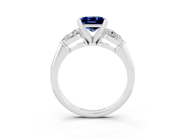 Platinum Three-Stone Princess Cut Blue Sapphire Ring with Pear Side Stones and Four-Prong Setting