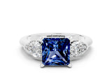 White gold Three-Stone Princess Cut Blue Sapphire Ring with Pear Side Stones and Four-Prong Setting