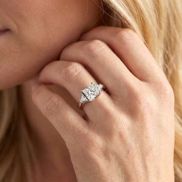 White gold Three-Stone Princess Cut Diamond Ring with Trillion Side Stones and Four-Prong Setting
