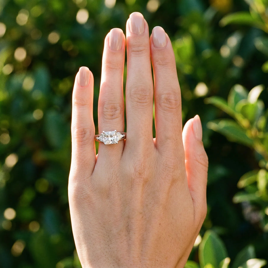 White gold Three-Stone Princess Cut Diamond Ring with Trillion Side Stones on a Split Shank Band