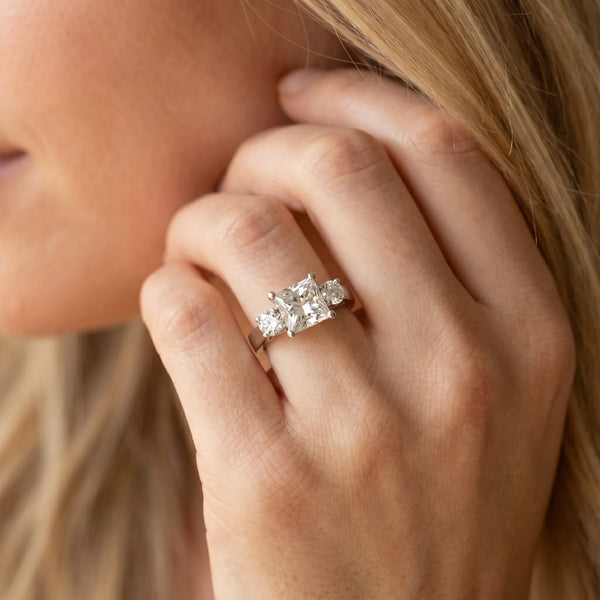 White gold Three-Stone Princess Cut Solitaire Ring with Round Side Stones and Four-Prong Setting