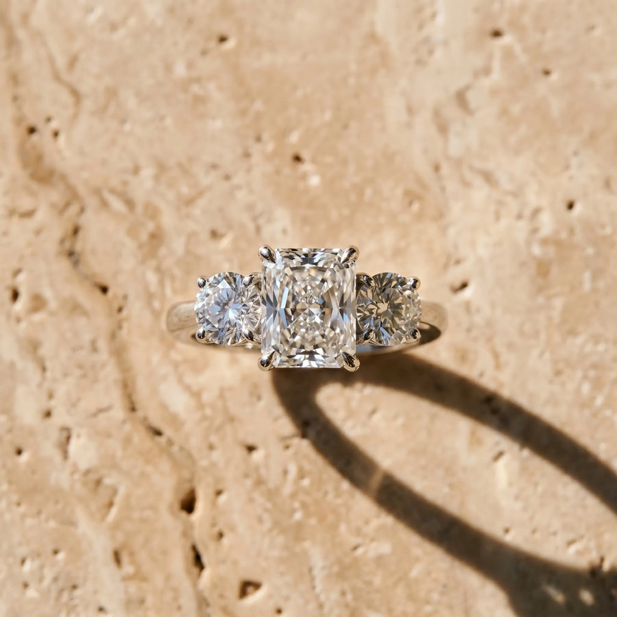 White gold Three-Stone Radiant Cut Diamond Engagement Ring with Prong Setting on a White Gold Band