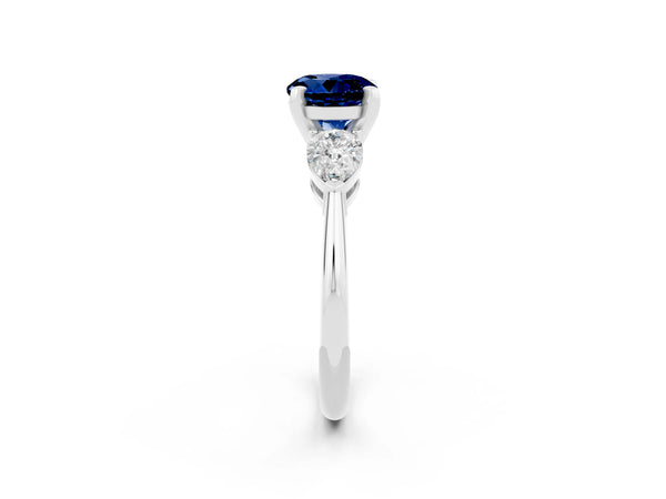 Silver Three-Stone Round Cut Blue Sapphire Ring with Pear Side Stones and Four-Prong Setting