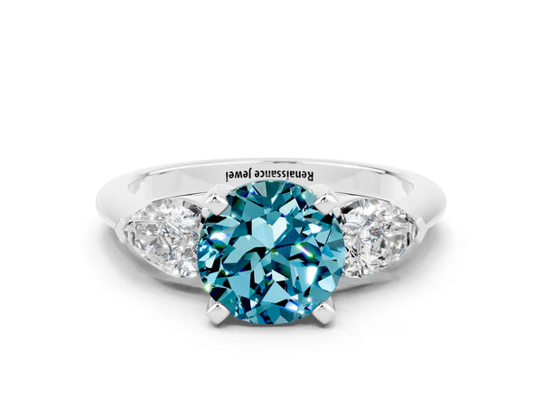 Silver Three-Stone Round Cut Blue Topaz Ring with Pear Side Stones and Four-Prong Setting