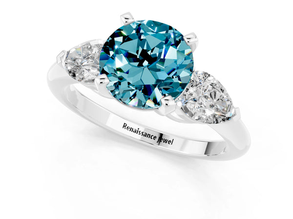 Silver Three-Stone Round Cut Blue Topaz Ring with Pear Side Stones and Four-Prong Setting