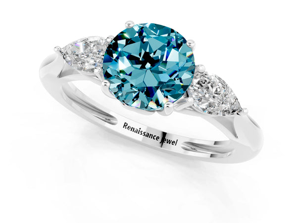 Platinum Three-Stone Round Cut Blue Topaz Ring with Pear  Side Stones in Four-Prong Setting